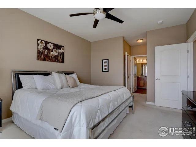 a bedroom with a bed and a view of kitchen