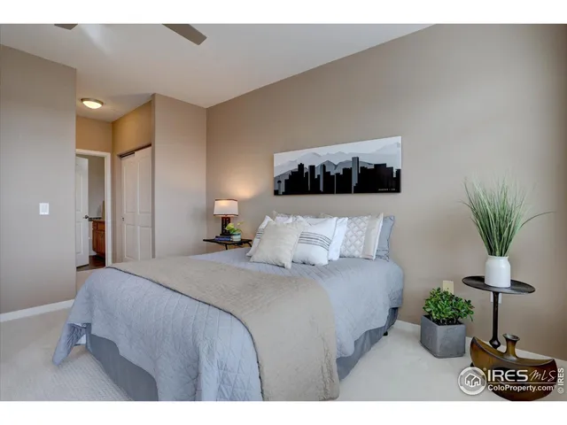 a bedroom with a bed and a potted plant