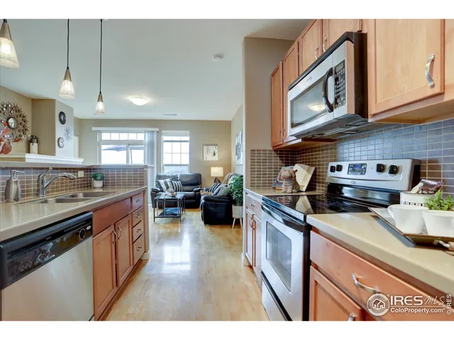 a kitchen with stainless steel appliances granite countertop a stove and cabinets