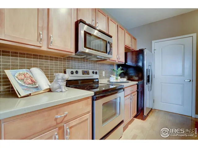 a kitchen with stainless steel appliances granite countertop a stove a microwave and cabinets