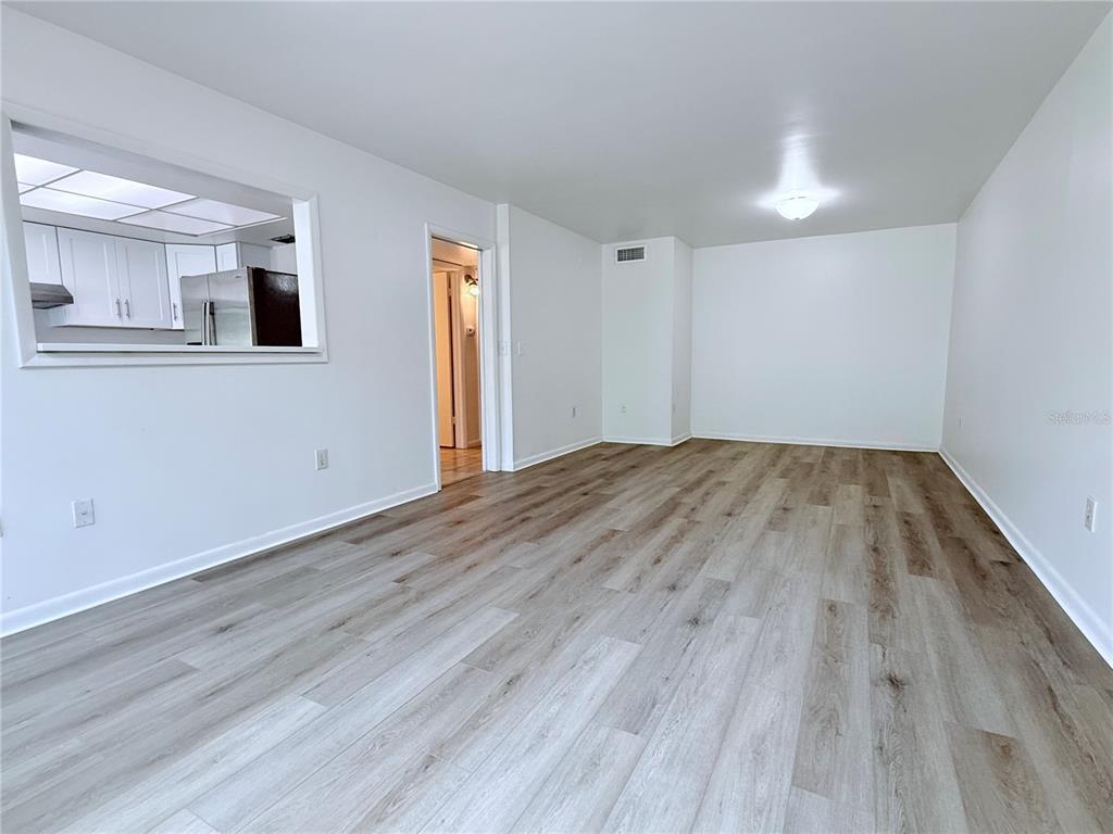 6206 Dewdrop Way Temple Terrace, FL 33617 - Photo 4 of 23 a view of empty room with wooden floor and fan