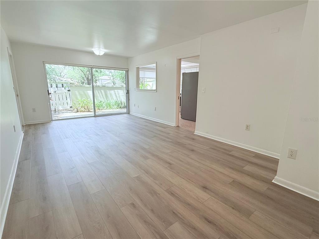 6206 Dewdrop Way Temple Terrace, FL 33617 - Photo 5 of 23 an empty room with wooden floor and windows