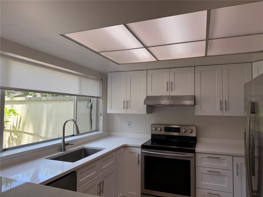 6206 Dewdrop Way Temple Terrace, FL 33617 - Photo 6 of 23 a kitchen with a sink cabinets and a stove