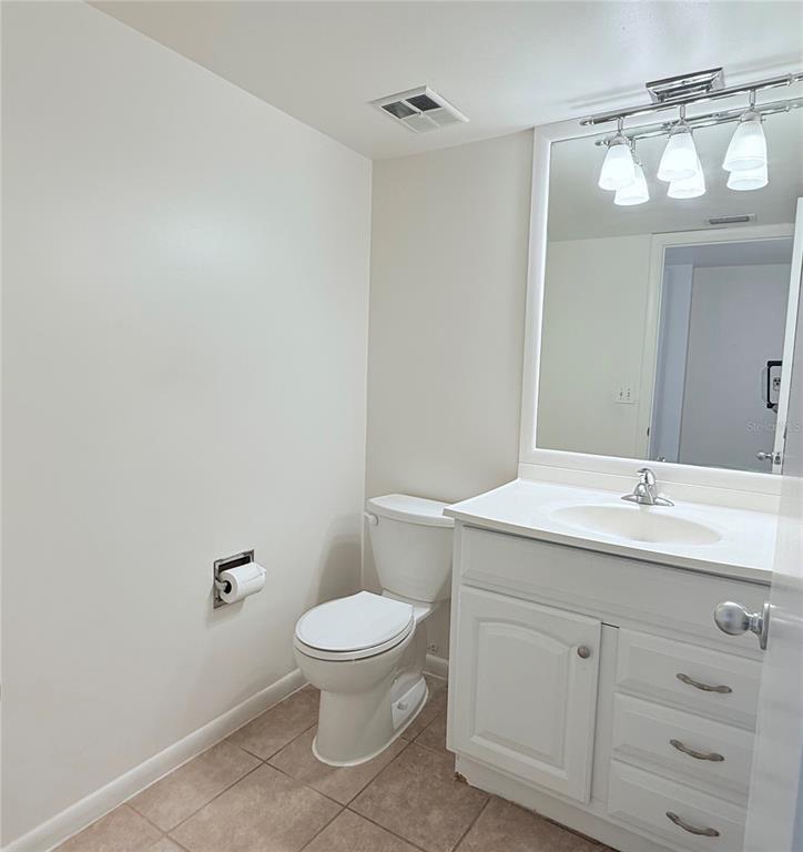6206 Dewdrop Way Temple Terrace, FL 33617 - Photo 7 of 23 a bathroom with a toilet a sink and mirror