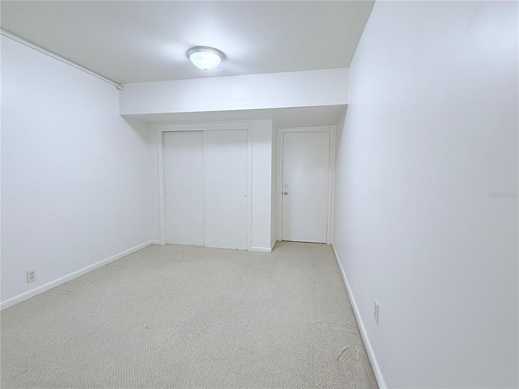 6206 Dewdrop Way Temple Terrace, FL 33617 - Photo 9 of 23 an empty room with a workbench