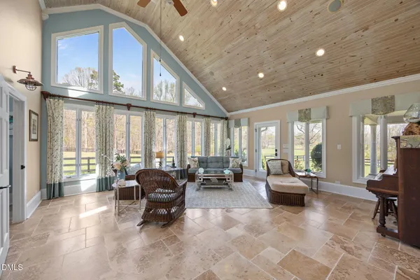 a living room with furniture a flat screen tv and a window