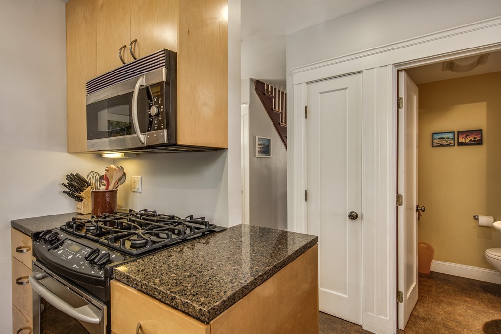 67 Cedar Road Medford, MA 02155 - Photo 11 of 30 a kitchen with a stove and a microwave
