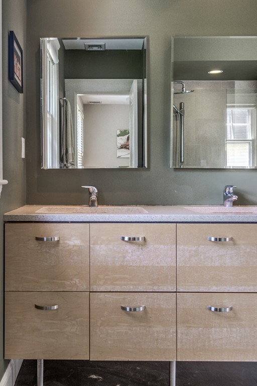67 Cedar Road Medford, MA 02155 - Photo 18 of 30 a close view of two sink a mirror and cabinets