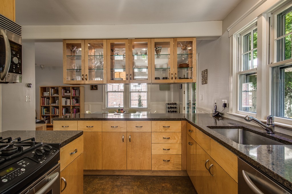 67 Cedar Road Medford, MA 02155 - Photo 10 of 30 a kitchen with granite countertop a stove a sink and a counter space