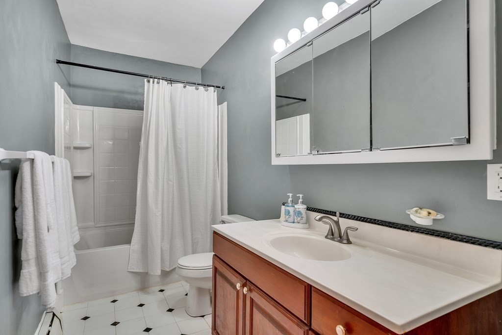 509 Neck Road, Unit 1 Lancaster, MA 01523 - Photo 13 of 19 a bathroom with a sink toilet a shower and a mirror