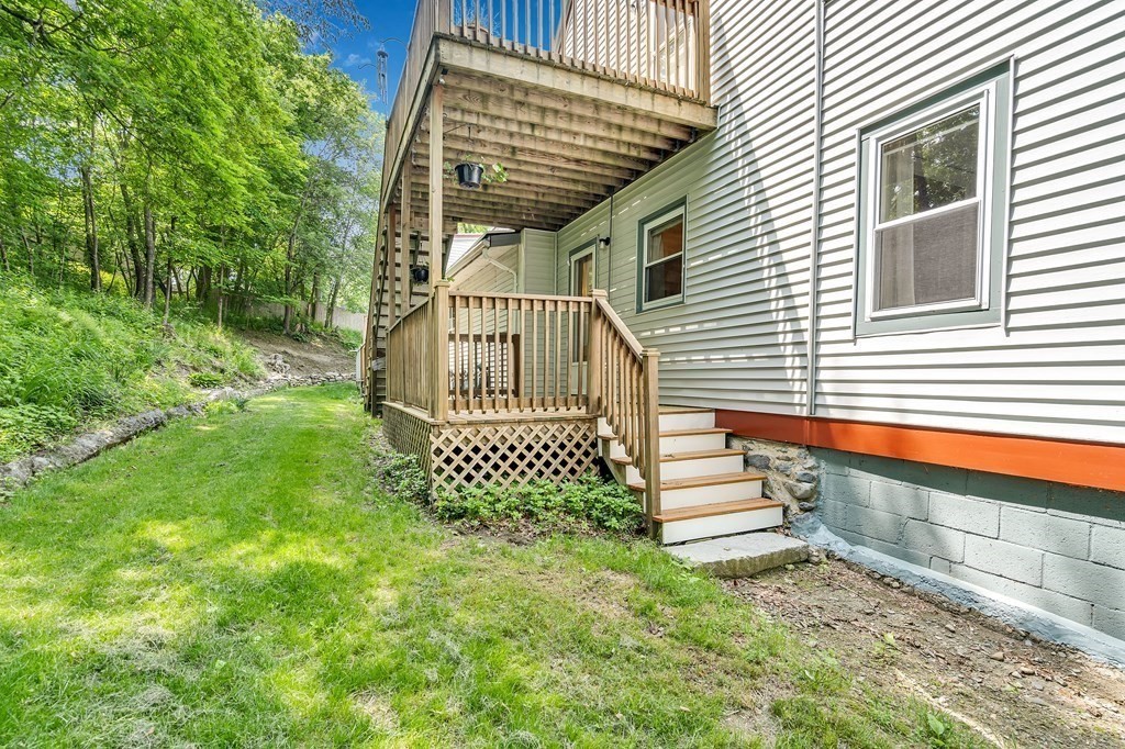 509 Neck Road, Unit 1 Lancaster, MA 01523 - Photo 17 of 19 a front view of a house with a yard