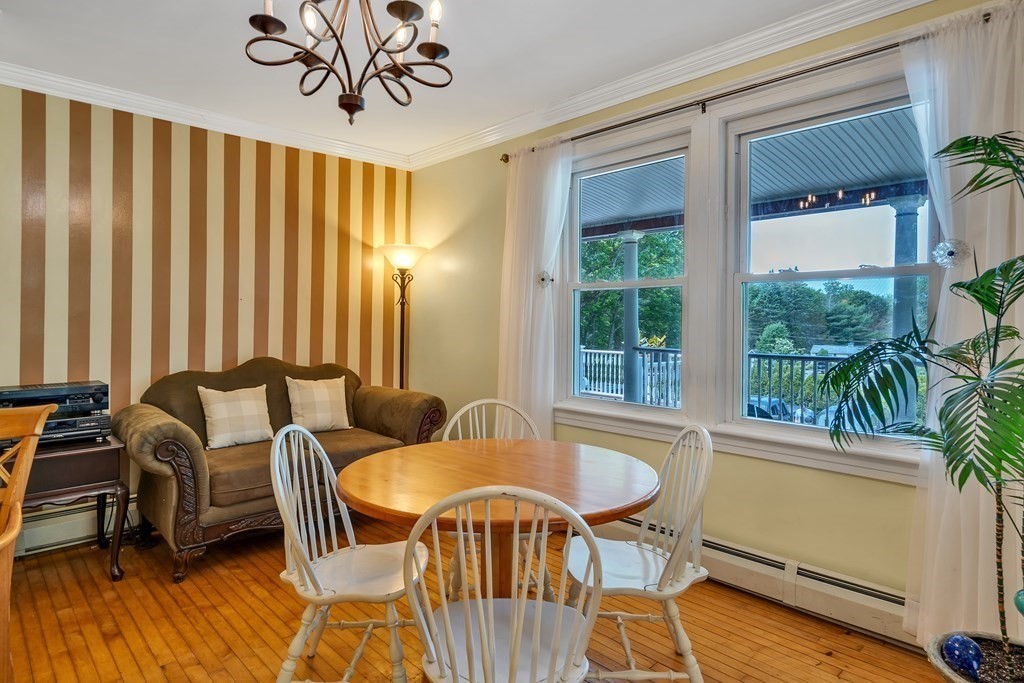 509 Neck Road, Unit 1 Lancaster, MA 01523 - Photo 8 of 19 a view of a dining room with furniture window and wooden floor