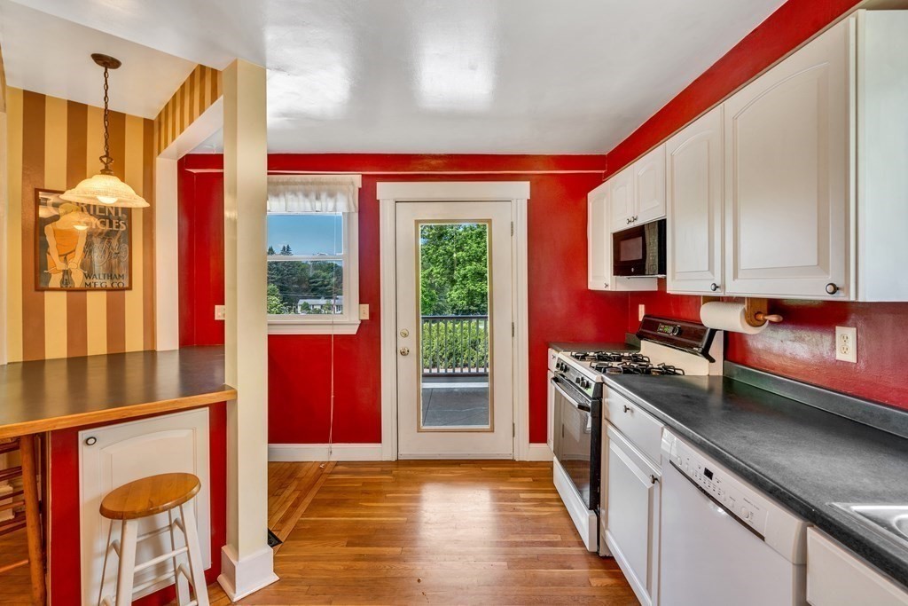 509 Neck Road, Unit 1 Lancaster, MA 01523 - Photo 10 of 19 a kitchen with stainless steel appliances granite countertop a stove a sink and a microwave