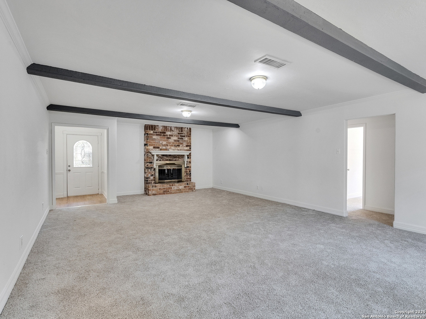 25423 Old Carriage Lane Spring, TX 77373 - Photo 11 of 36 a view of an empty room with a fireplace and a window