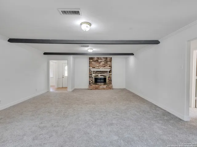 a view of an empty room and fire place