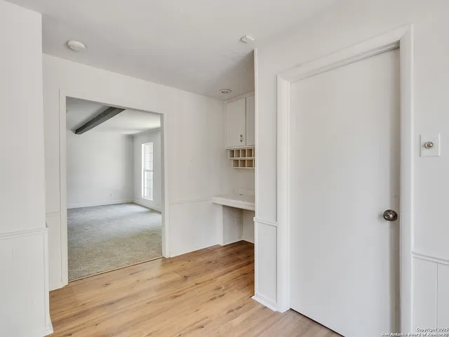 a view of hallway with wooden floor