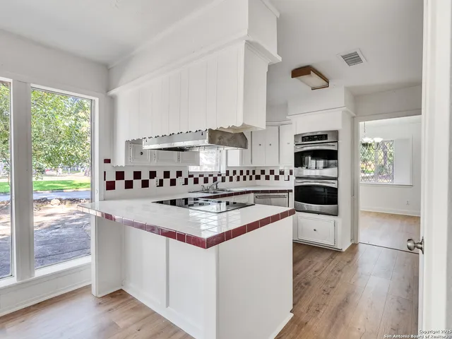a kitchen with stainless steel appliances granite countertop a stove and a sink