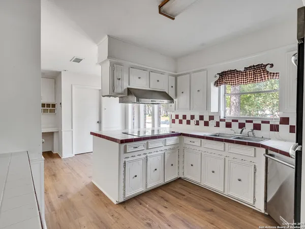a kitchen with stainless steel appliances granite countertop a sink and cabinets