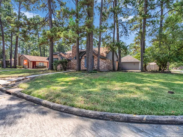 a view of a house with yard and sitting area