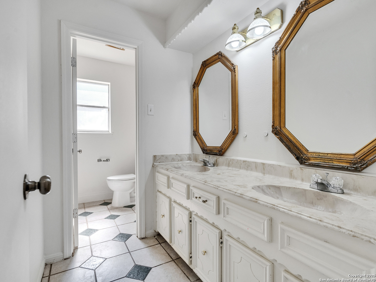 25423 Old Carriage Lane Spring, TX 77373 - Photo 22 of 36 a bathroom with a granite countertop sink a toilet and a mirror