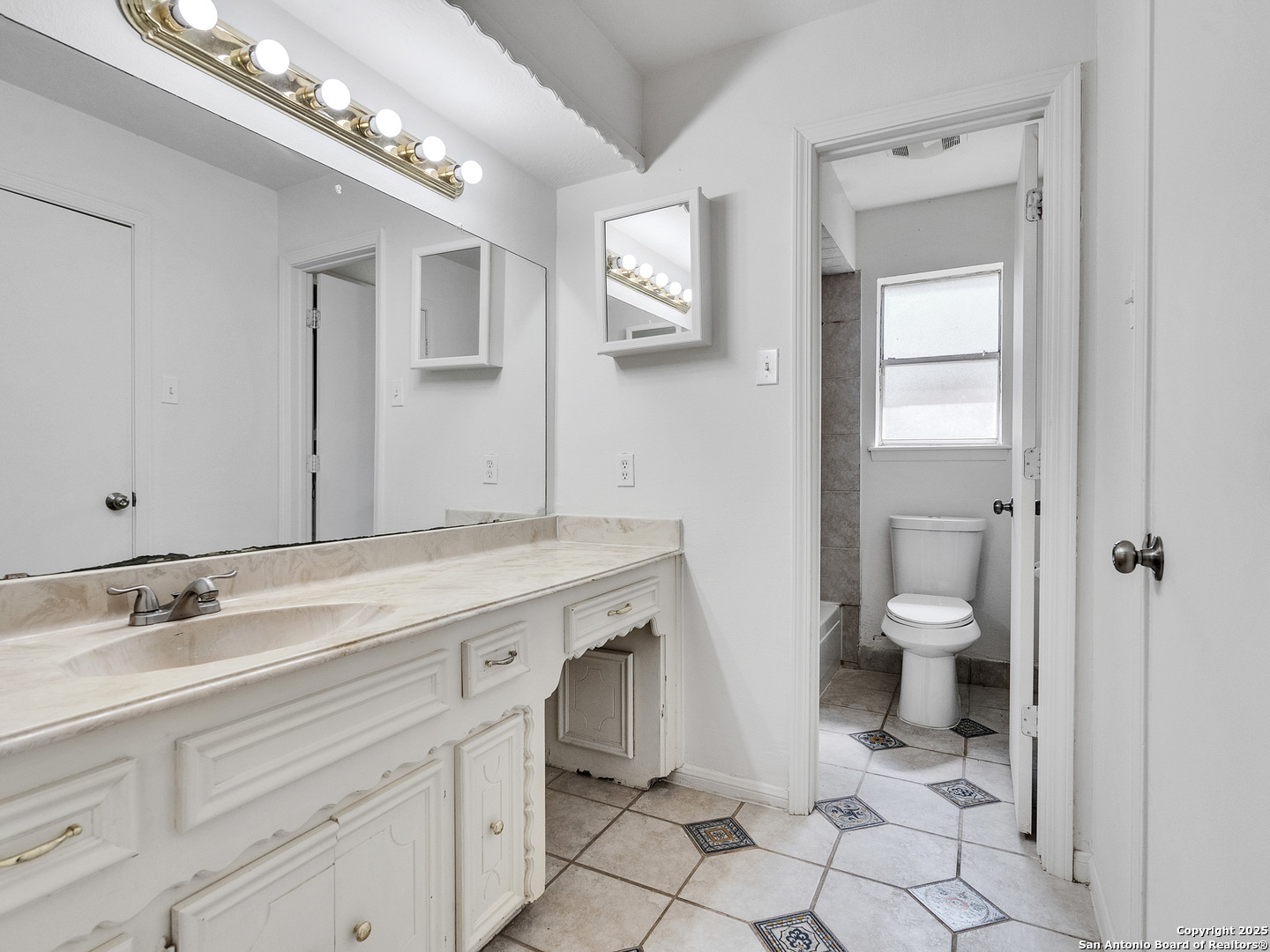 25423 Old Carriage Lane Spring, TX 77373 - Photo 27 of 36 a spacious bathroom with a granite countertop toilet sink and mirror