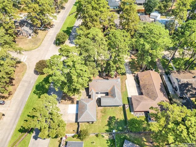 an aerial view of a house with garden space and street view