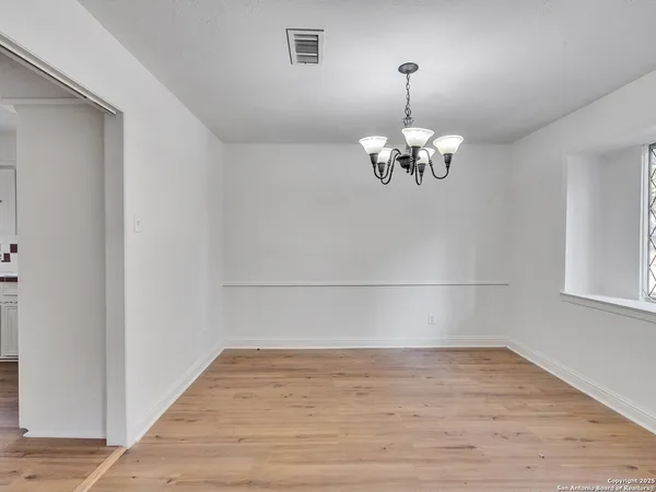 a view of a chandelier in wooden floor