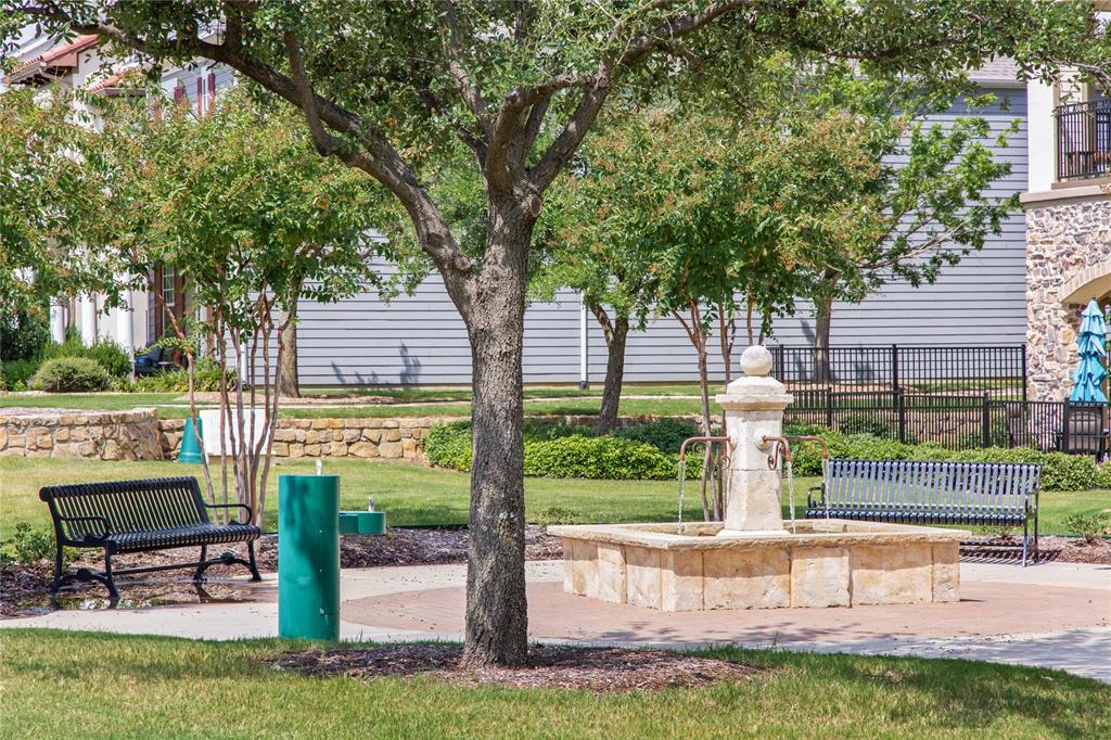 516 Sandy Lane Flower Mound, TX 75022 - Photo 32 of 38 Park-like grounds featuring a stone fountain, mature trees, and multiple benches