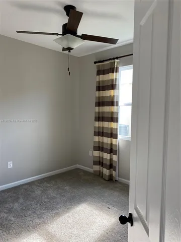 a view of room with a ceiling fan