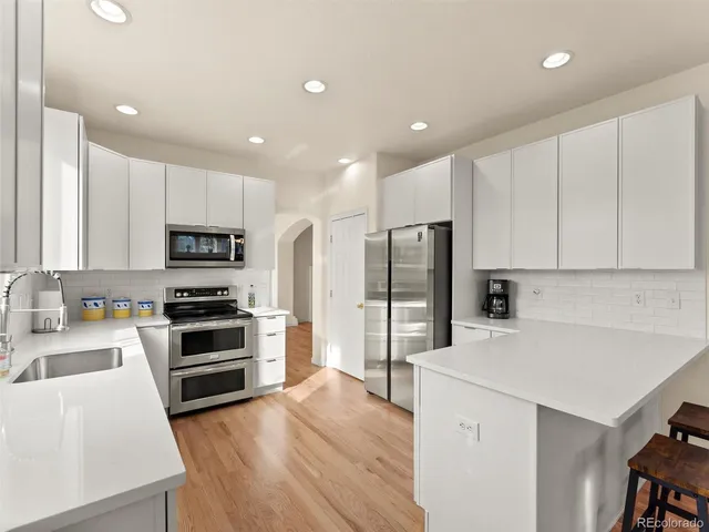 a kitchen with stainless steel appliances a refrigerator and a sink