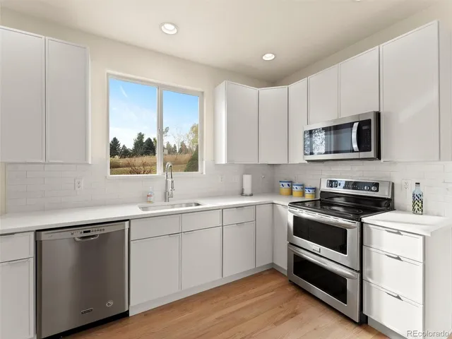 a kitchen with a sink stove and microwave