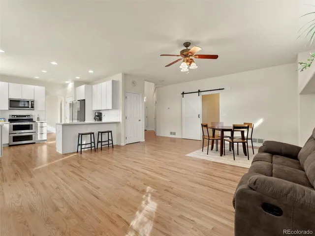 a living room with furniture and kitchen view