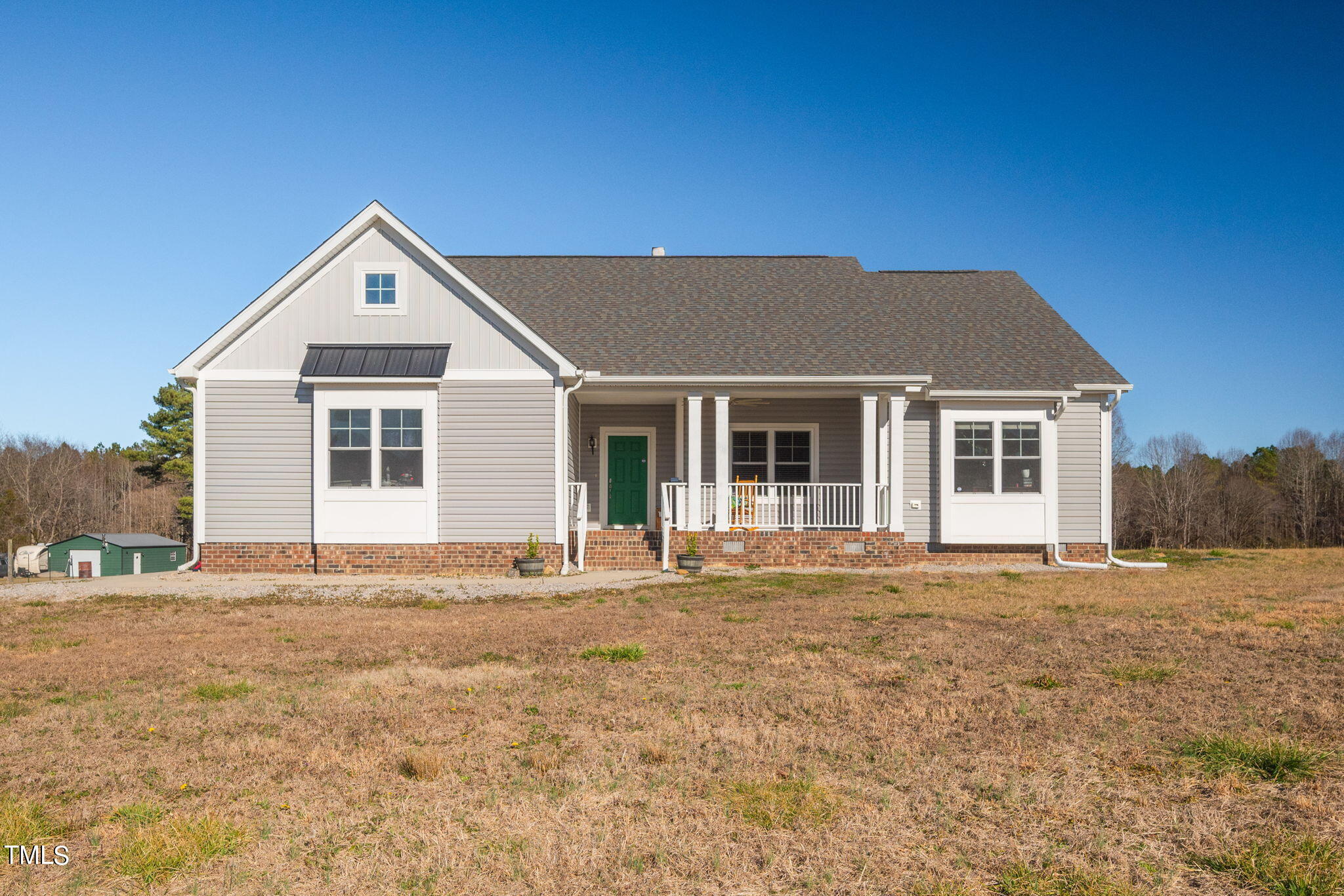 1428 Spring Valley Lake Road Henderson, NC 27537 - Photo 1 of 92 a front view of a house with a garden