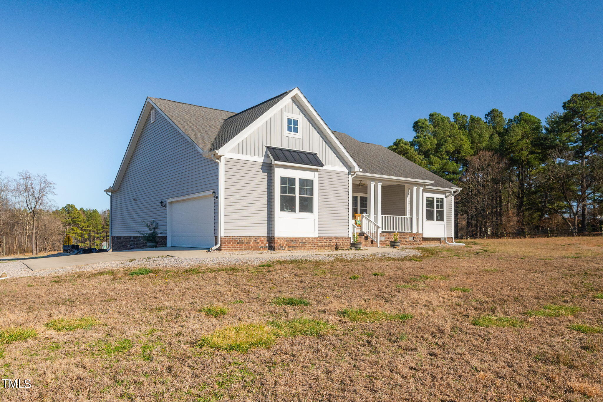 1428 Spring Valley Lake Road Henderson, NC 27537 - Photo 2 of 92 a front view of a house with a garden