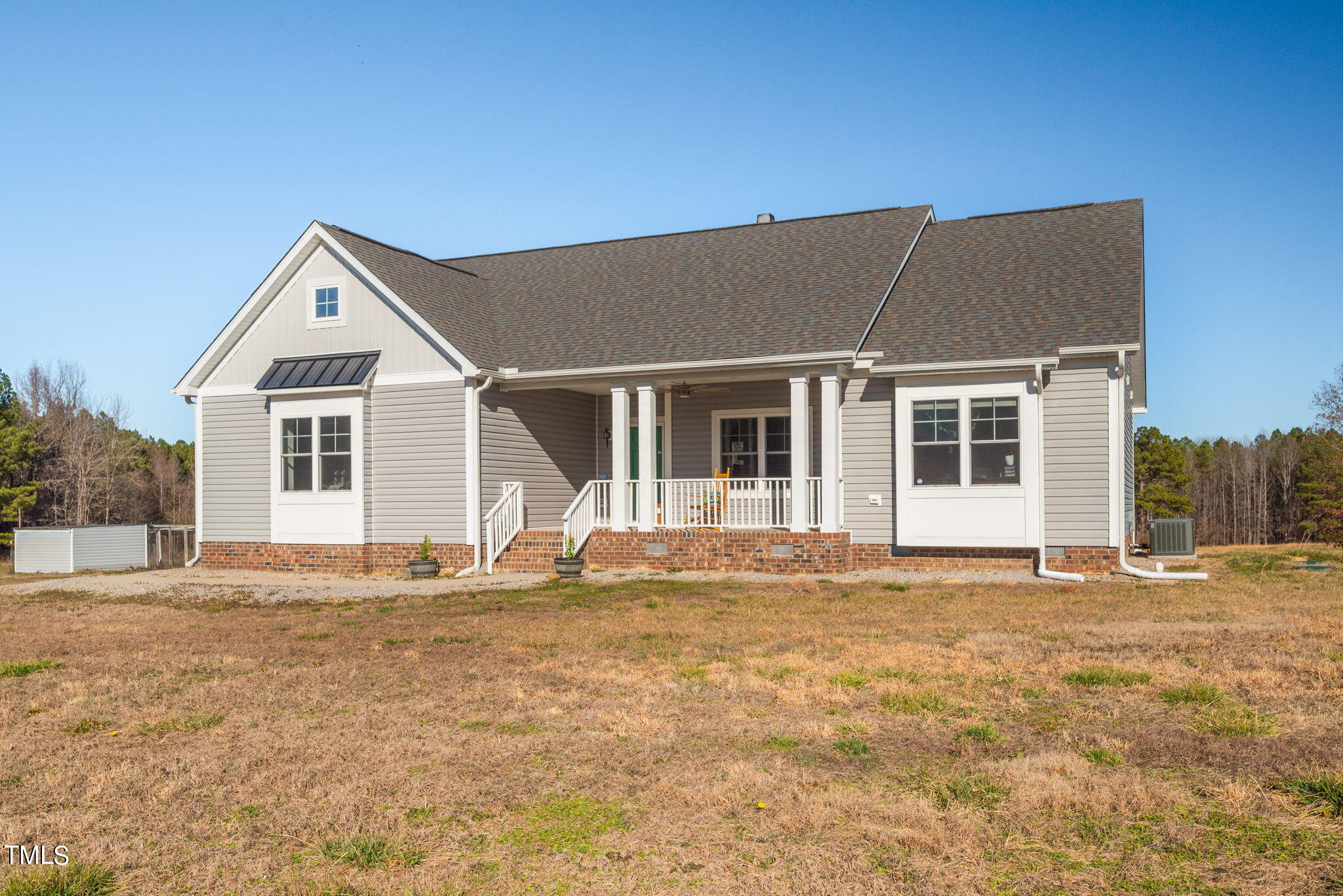 1428 Spring Valley Lake Road Henderson, NC 27537 - Photo 3 of 92 a front view of a house with a yard