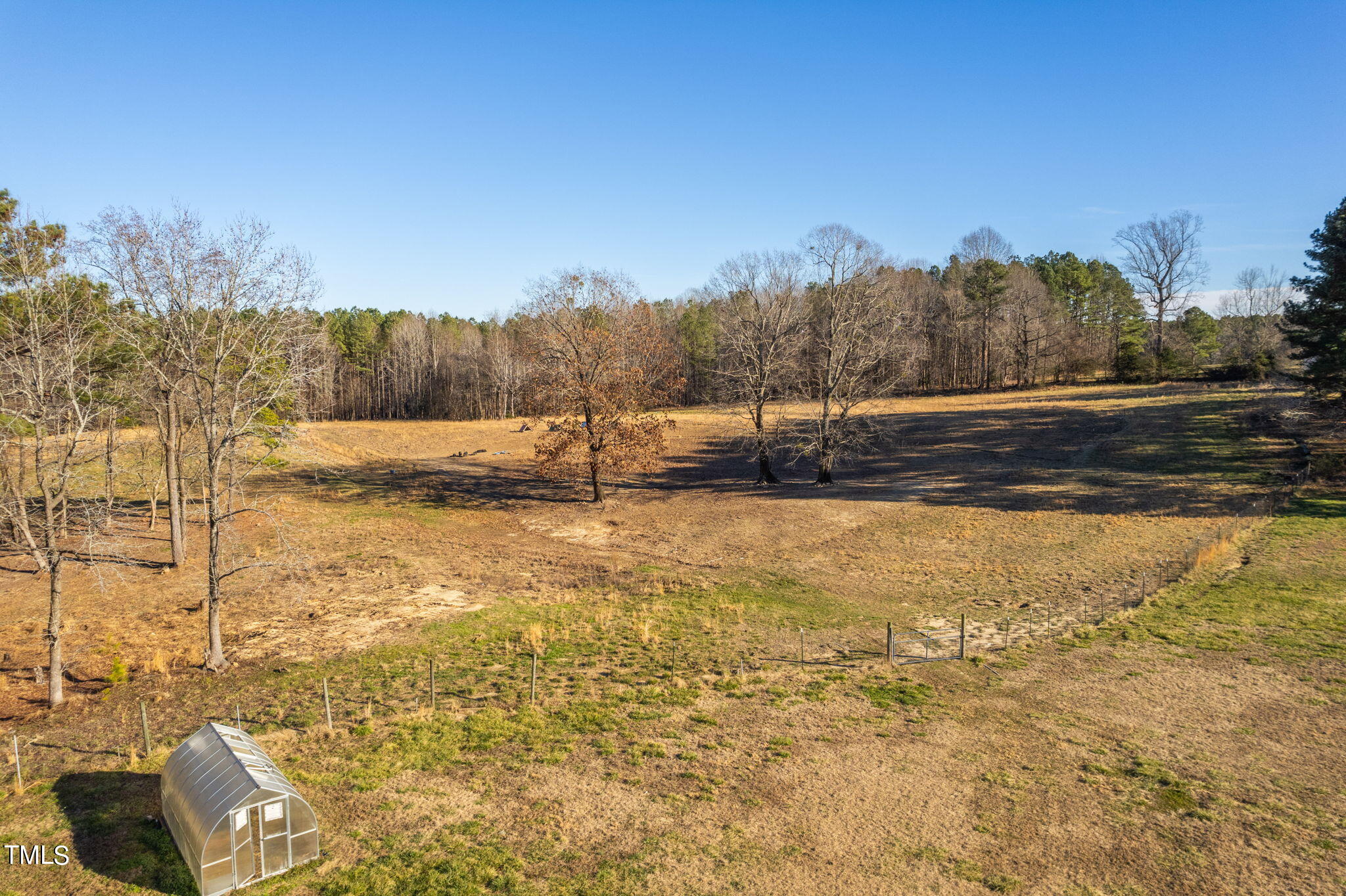 1428 Spring Valley Lake Road Henderson, NC 27537 - Photo 40 of 92 a view of a yard with an outdoor space