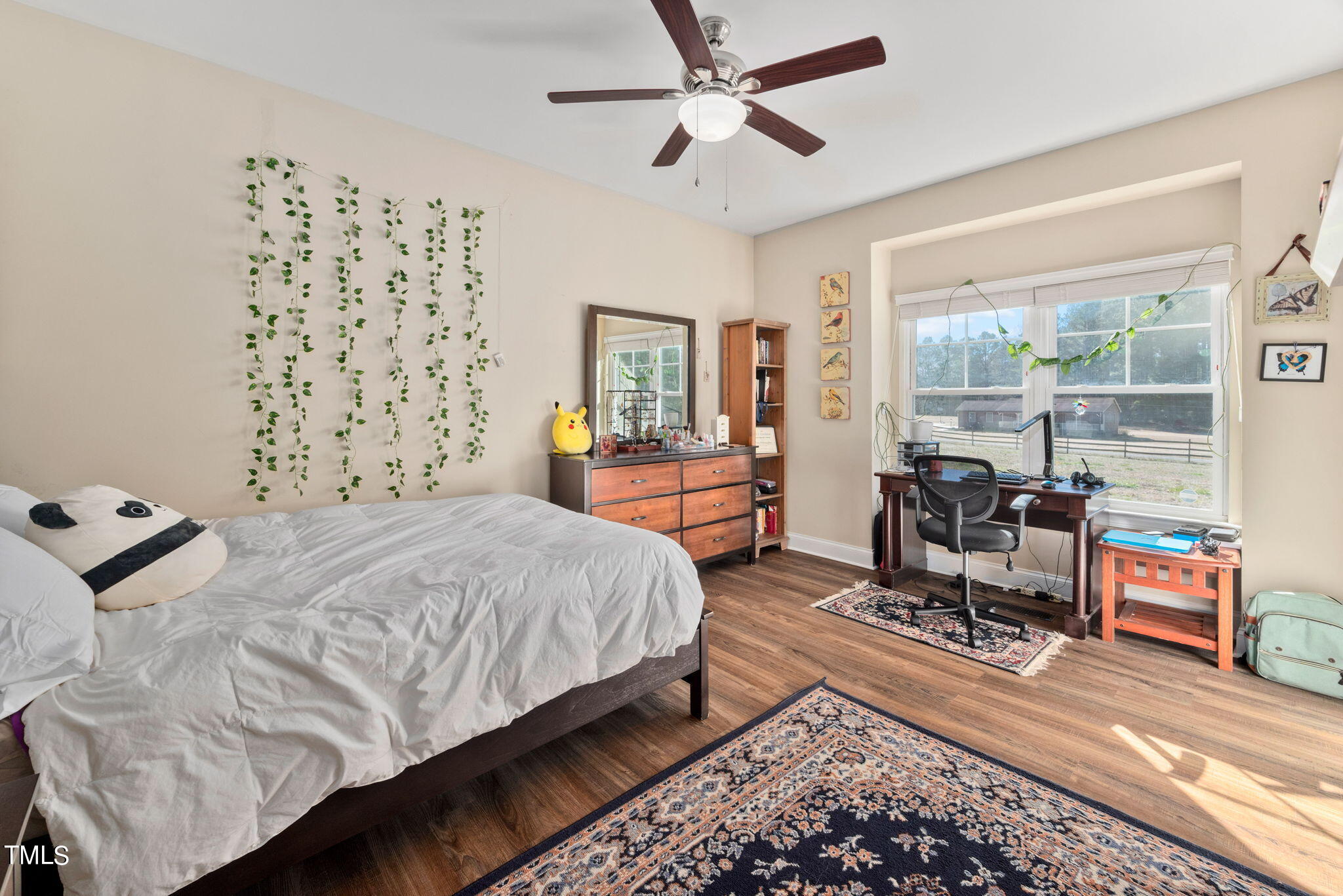 1428 Spring Valley Lake Road Henderson, NC 27537 - Photo 45 of 92 a bedroom with a bed and wooden floor