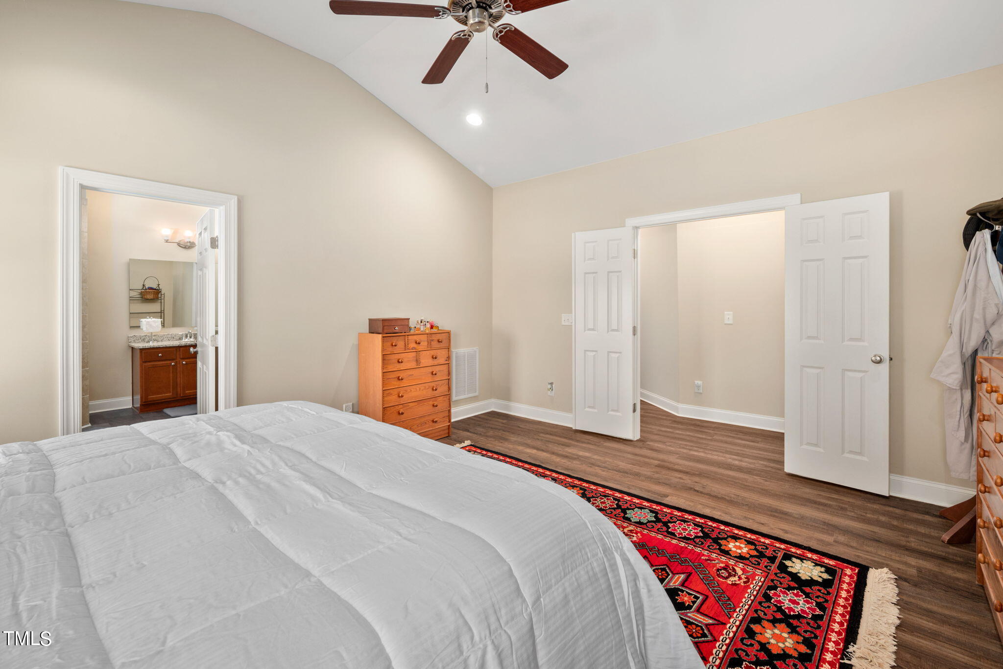 1428 Spring Valley Lake Road Henderson, NC 27537 - Photo 48 of 92 a bedroom with a large bed and a chandelier