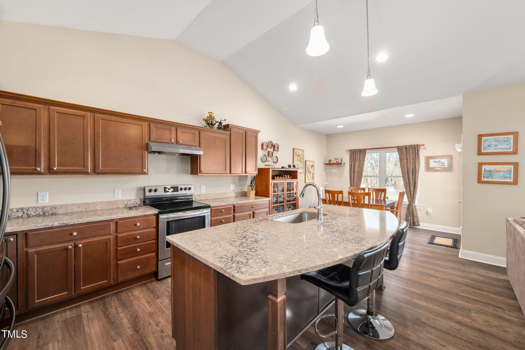 1428 Spring Valley Lake Road Henderson, NC 27537 - Photo 61 of 92 a kitchen with stainless steel appliances granite countertop a stove a sink dishwasher a stove a refrigerator a dining table and chairs with wooden floor