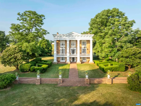 a view of a house with a yard and sitting area