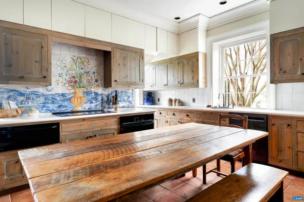 a kitchen with stainless steel appliances granite countertop a stove and cabinets