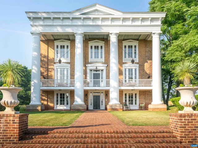 a front view of a residential apartment building with a yard