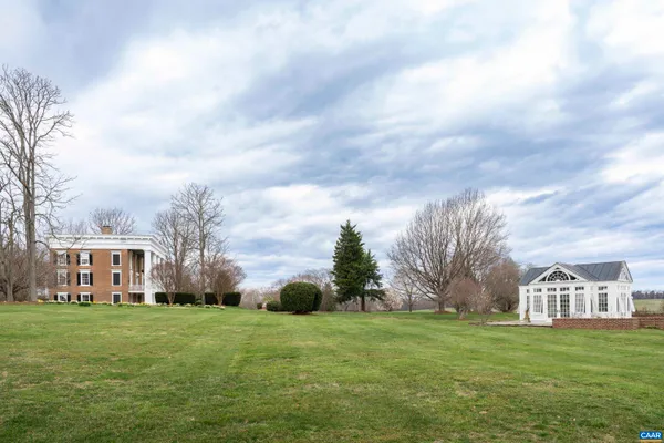 a view of house with yard and green space