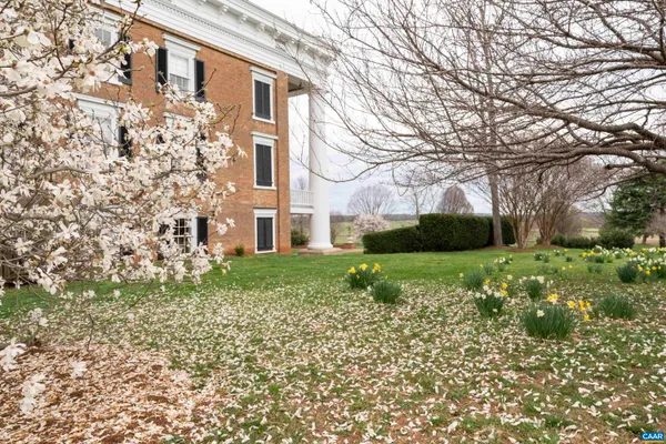 a kitchen with granite countertop white cabinets and a sink