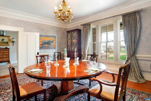 a kitchen with stainless steel appliances wooden cabinets dining table and chairs