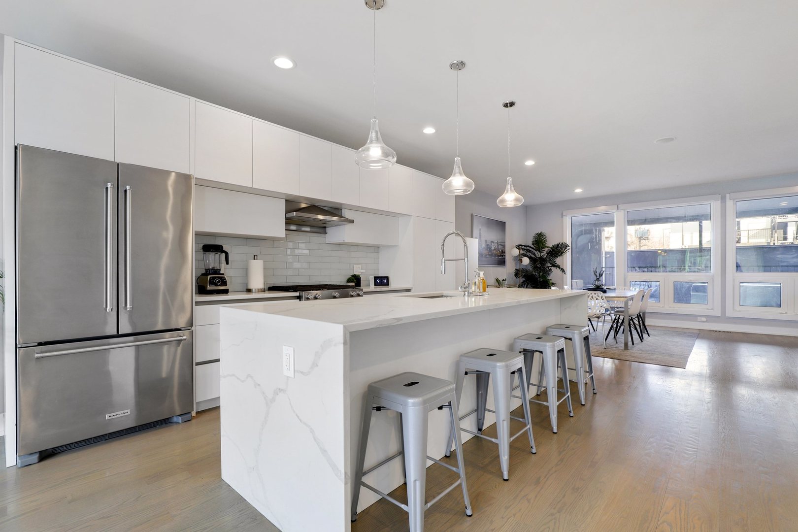 730 West 17th Place, Unit 1W Chicago, IL 60616 - Photo 3 of 26 a kitchen with stainless steel appliances granite countertop a refrigerator a stove a sink a dining table and chairs
