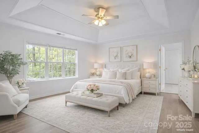 a spacious bedroom with a bed and a chandelier