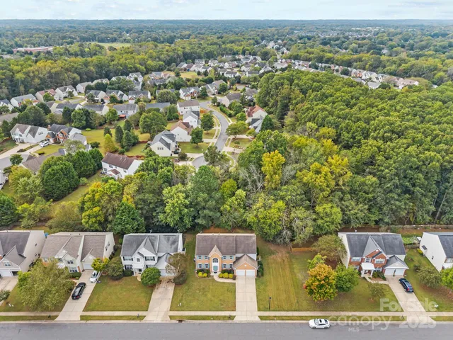 a view of empty room with wooden floor and fireplace