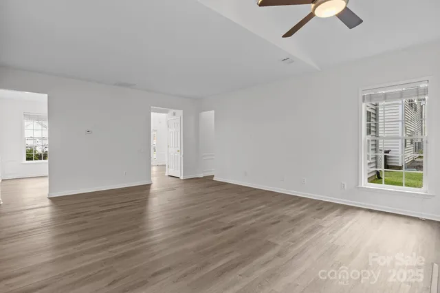 a kitchen with stainless steel appliances granite countertop a stove top oven a sink and dishwasher a refrigerator with wooden floor