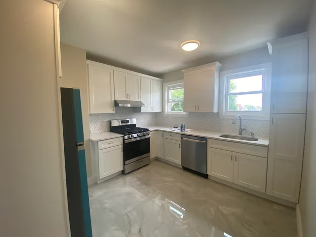 a kitchen with a sink stove and refrigerator